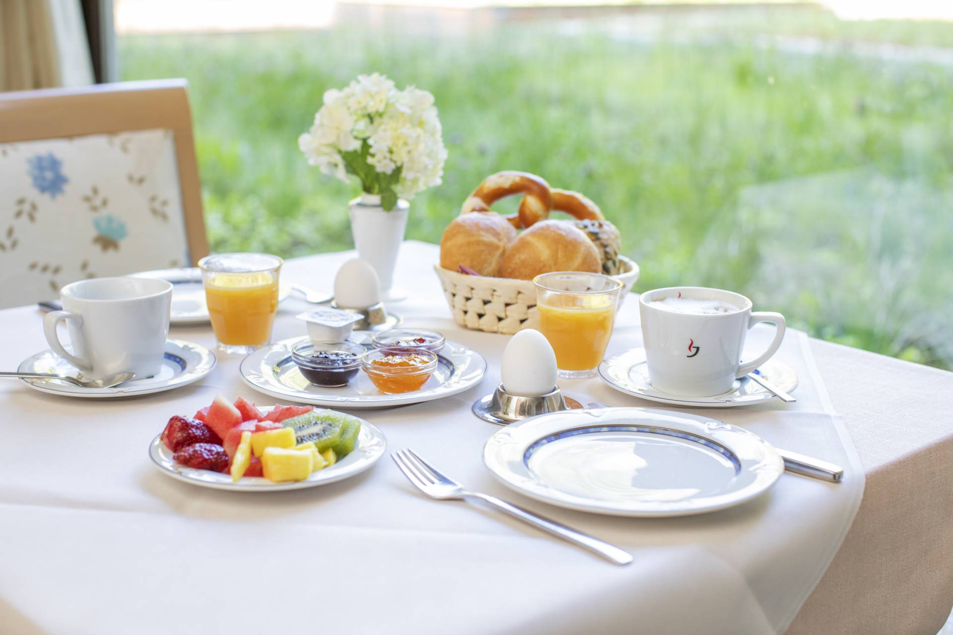 Frühstückstisch gedeckt mit Früchten, Marmeladen und Gebäck